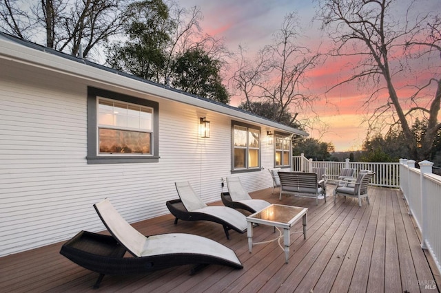 deck at dusk with outdoor lounge area