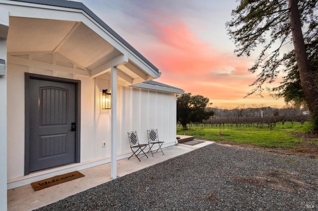 exterior entry at dusk with a patio area