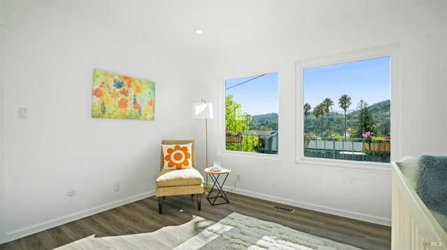 living area featuring visible vents, baseboards, wood finished floors, and recessed lighting