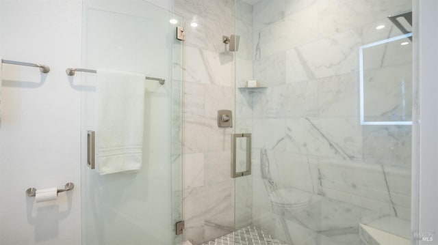 bathroom with a marble finish shower