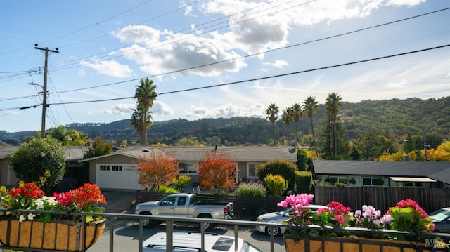 view of front of home with an attached garage and fence