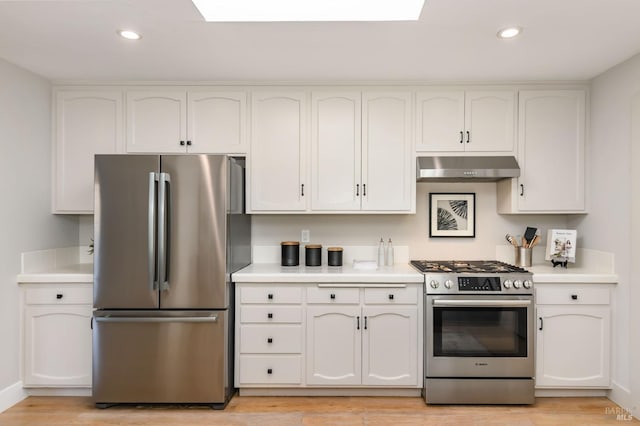 kitchen featuring under cabinet range hood, appliances with stainless steel finishes, light countertops, and recessed lighting