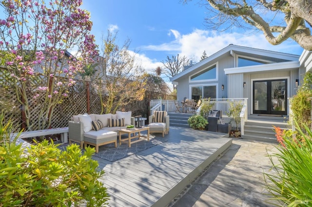 wooden deck with fence and an outdoor living space