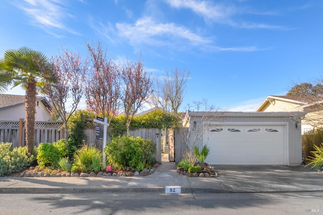 view of front of house featuring a garage and fence