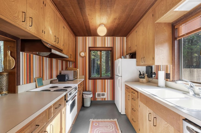 kitchen with white appliances, a sink, visible vents, light countertops, and wallpapered walls