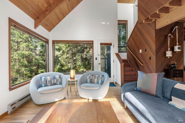 interior space featuring wooden ceiling, stairway, wood finished floors, baseboard heating, and high vaulted ceiling