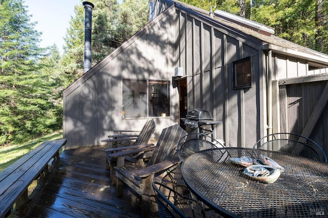 deck featuring a grill and outdoor dining area