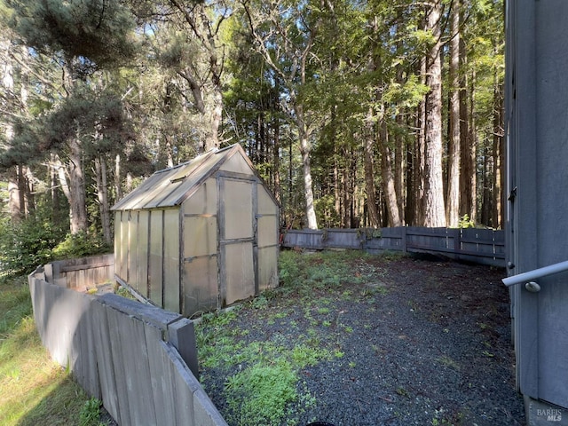 view of greenhouse featuring fence