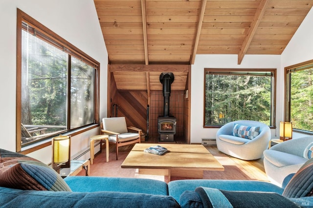 living room featuring lofted ceiling with beams, a baseboard heating unit, wood finished floors, baseboard heating, and a wood stove