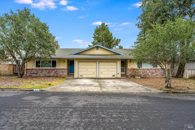 single story home with a garage, brick siding, a shingled roof, fence, and driveway