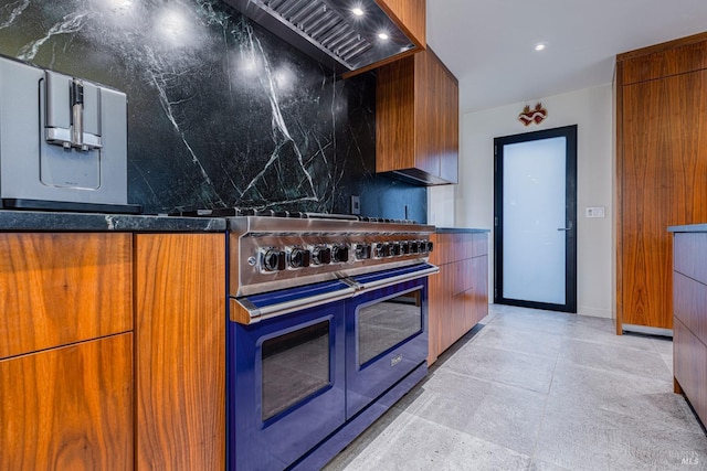 kitchen featuring tasteful backsplash, modern cabinets, and double oven range