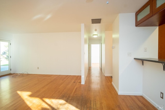 interior space with baseboards, visible vents, and light wood-style floors