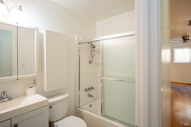 full bath featuring visible vents, toilet, shower / bath combination with glass door, ceiling fan, and vanity