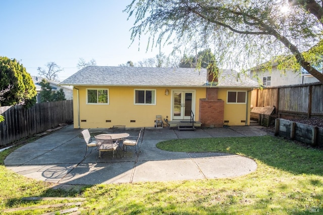 rear view of house featuring french doors, crawl space, a fenced backyard, and a lawn