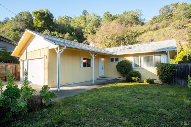 view of front of home with a front lawn and fence