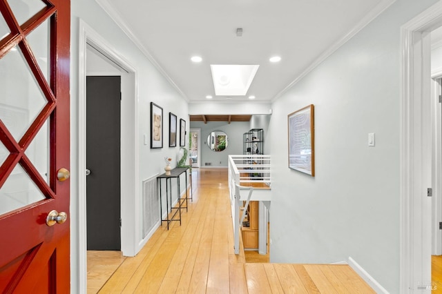 hall featuring ornamental molding, hardwood / wood-style floors, a skylight, and recessed lighting