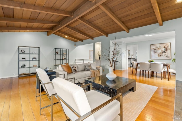 living room featuring vaulted ceiling with beams, wooden ceiling, light wood-style flooring, and baseboards