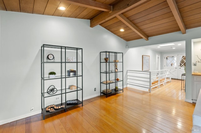 interior space with wood ceiling, lofted ceiling with beams, baseboards, and hardwood / wood-style flooring