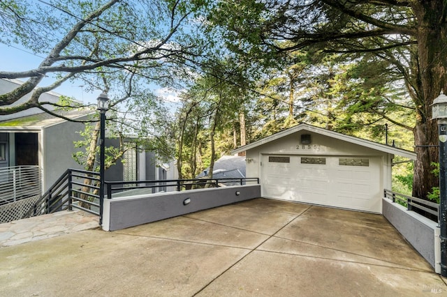 view of home's exterior featuring an outdoor structure, a detached garage, and stucco siding