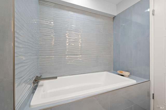 full bath with a relaxing tiled tub and tile walls