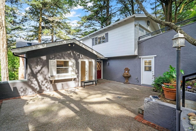 view of front of home featuring stucco siding and a patio