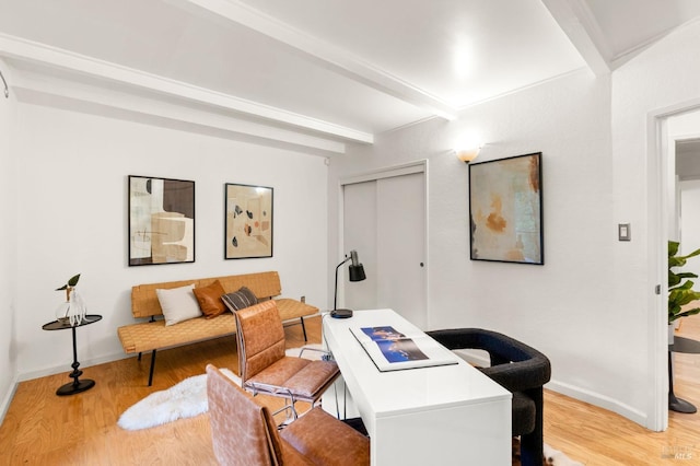 office featuring light wood-type flooring, beam ceiling, and baseboards