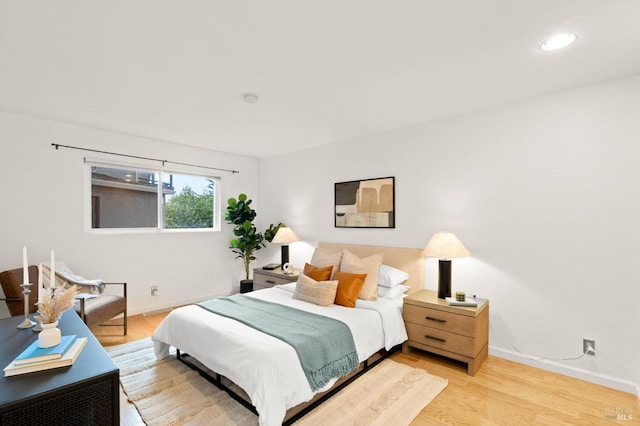 bedroom featuring light wood-style flooring and baseboards