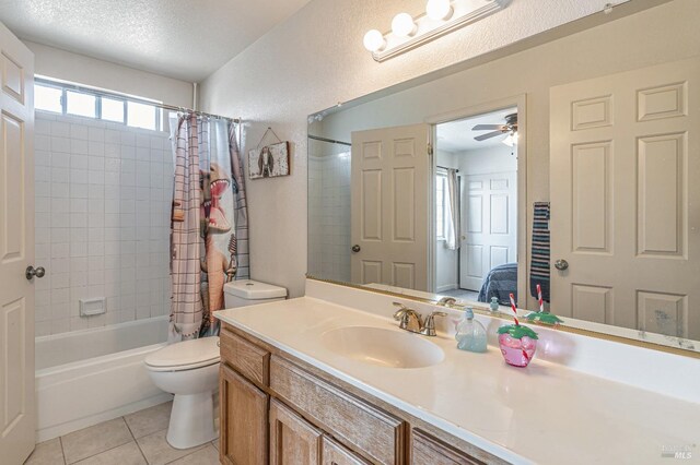 ensuite bathroom with shower / tub combo, toilet, tile patterned floors, a textured ceiling, and vanity