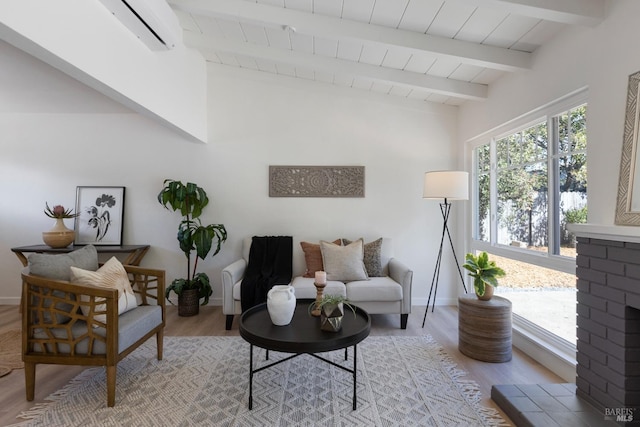 living area with lofted ceiling with beams, light wood-style floors, wood ceiling, and baseboards