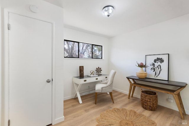 office area featuring light wood-style floors and baseboards