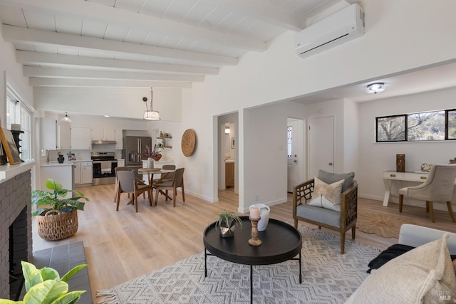 living area featuring a wall unit AC, a brick fireplace, lofted ceiling with beams, and light wood-style floors