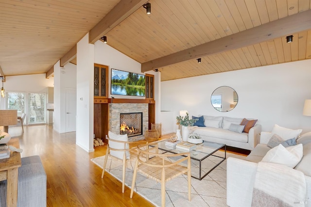 living area with a fireplace, vaulted ceiling with beams, light wood-style flooring, wood ceiling, and baseboards