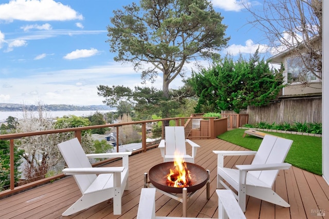 wooden deck featuring a fire pit and fence