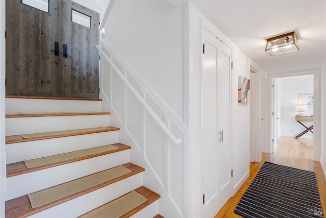 stairway with wood finished floors