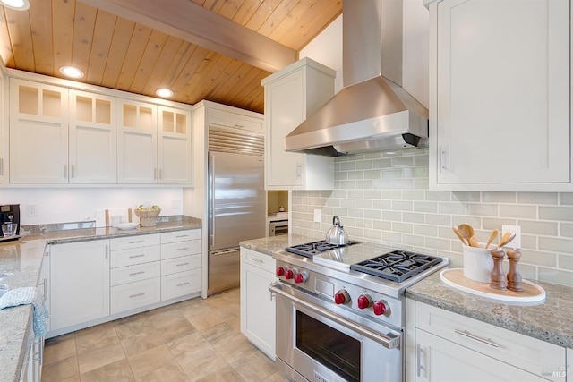 kitchen with white cabinets, wall chimney range hood, and high end appliances