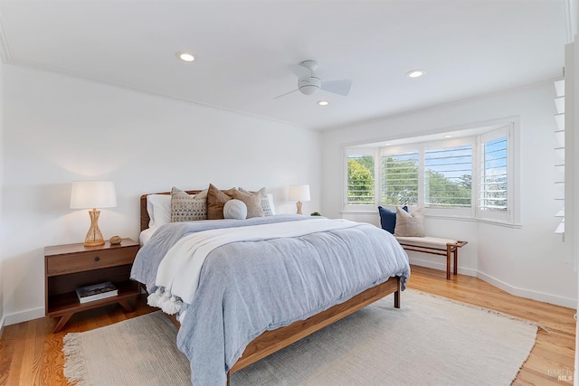 bedroom with light wood finished floors, ceiling fan, baseboards, and recessed lighting