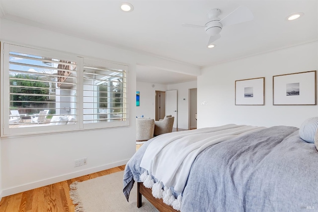 bedroom featuring a ceiling fan, recessed lighting, baseboards, and wood finished floors