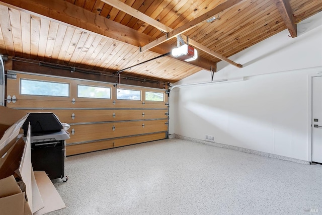 garage featuring a garage door opener, wood ceiling, and baseboards