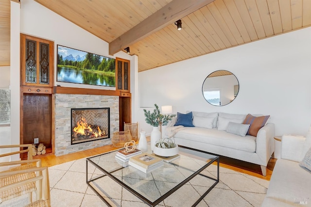 living room with wooden ceiling, a fireplace, vaulted ceiling with beams, and wood finished floors