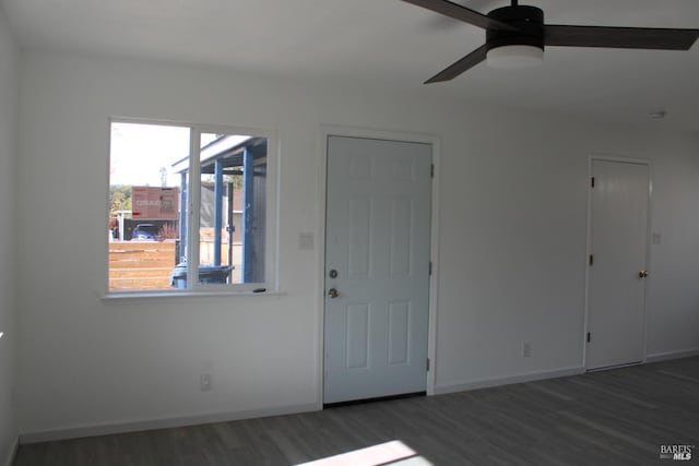 unfurnished room featuring ceiling fan, baseboards, and wood finished floors