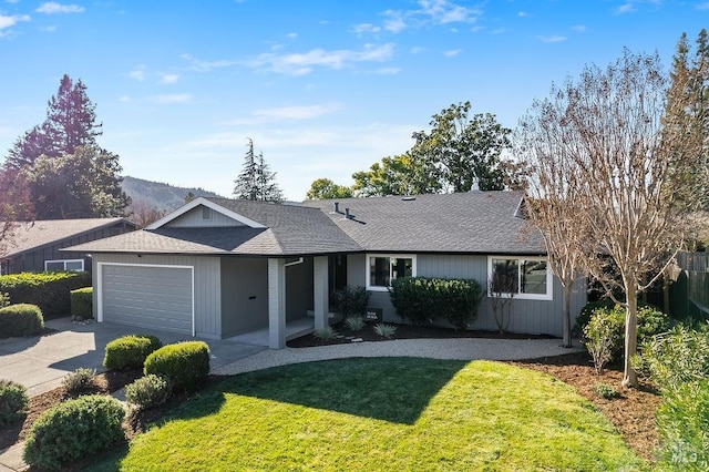 single story home with a garage, driveway, roof with shingles, fence, and a front yard