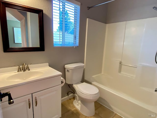 bathroom featuring tub / shower combination, vanity, and toilet