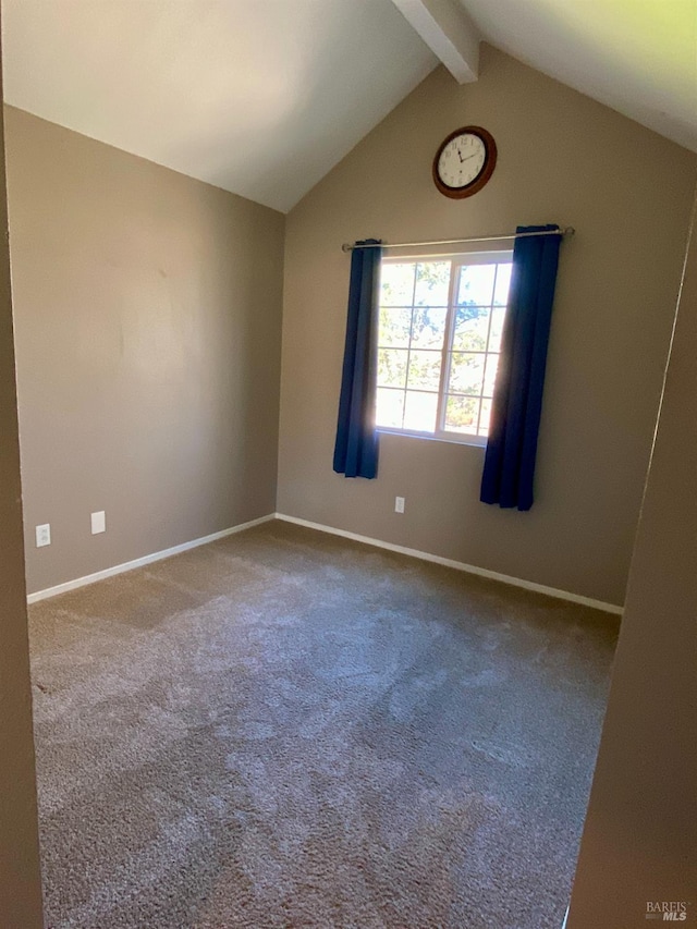 spare room featuring lofted ceiling with beams, carpet, and baseboards