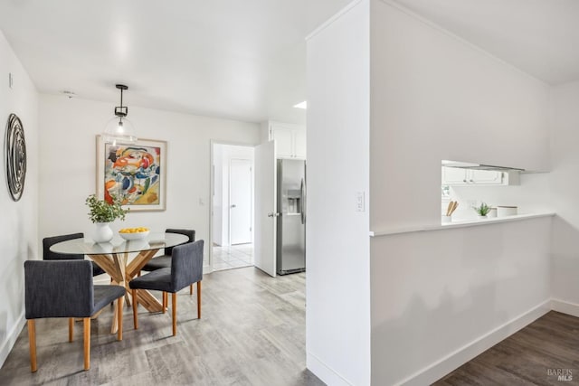 dining area featuring baseboards and wood finished floors