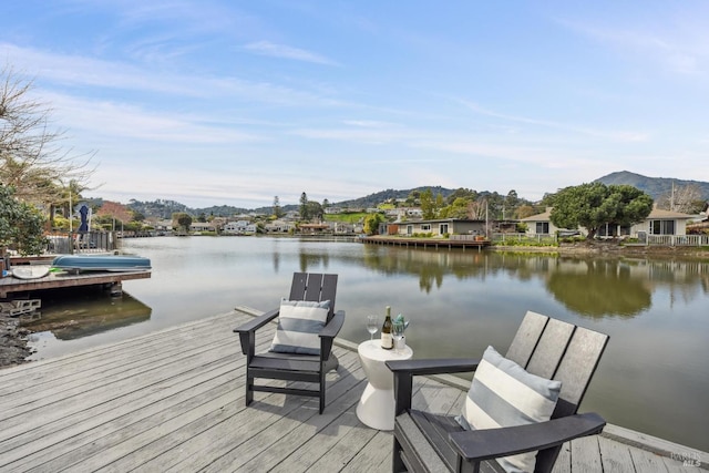 view of dock featuring a water and mountain view