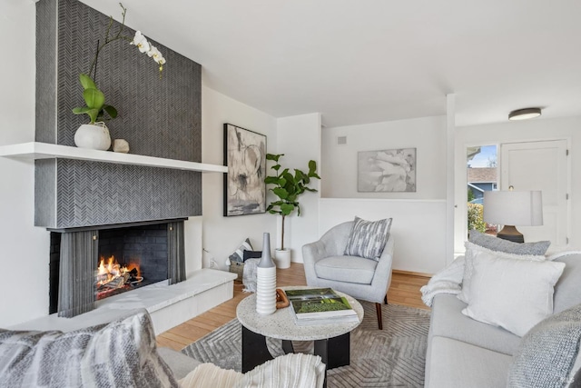 living area with a fireplace and wood finished floors