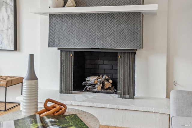 details featuring a fireplace with raised hearth