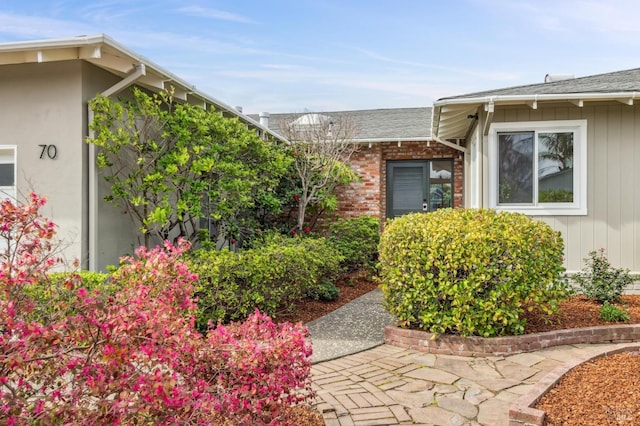 property entrance with brick siding