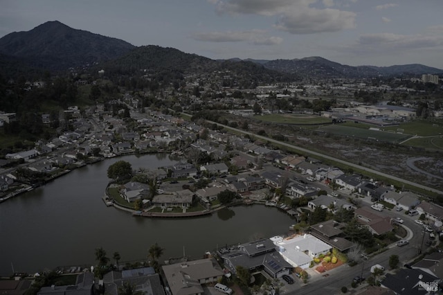 drone / aerial view featuring a residential view and a water and mountain view