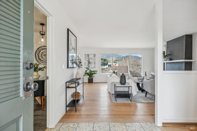 interior space featuring wood-type flooring and baseboards